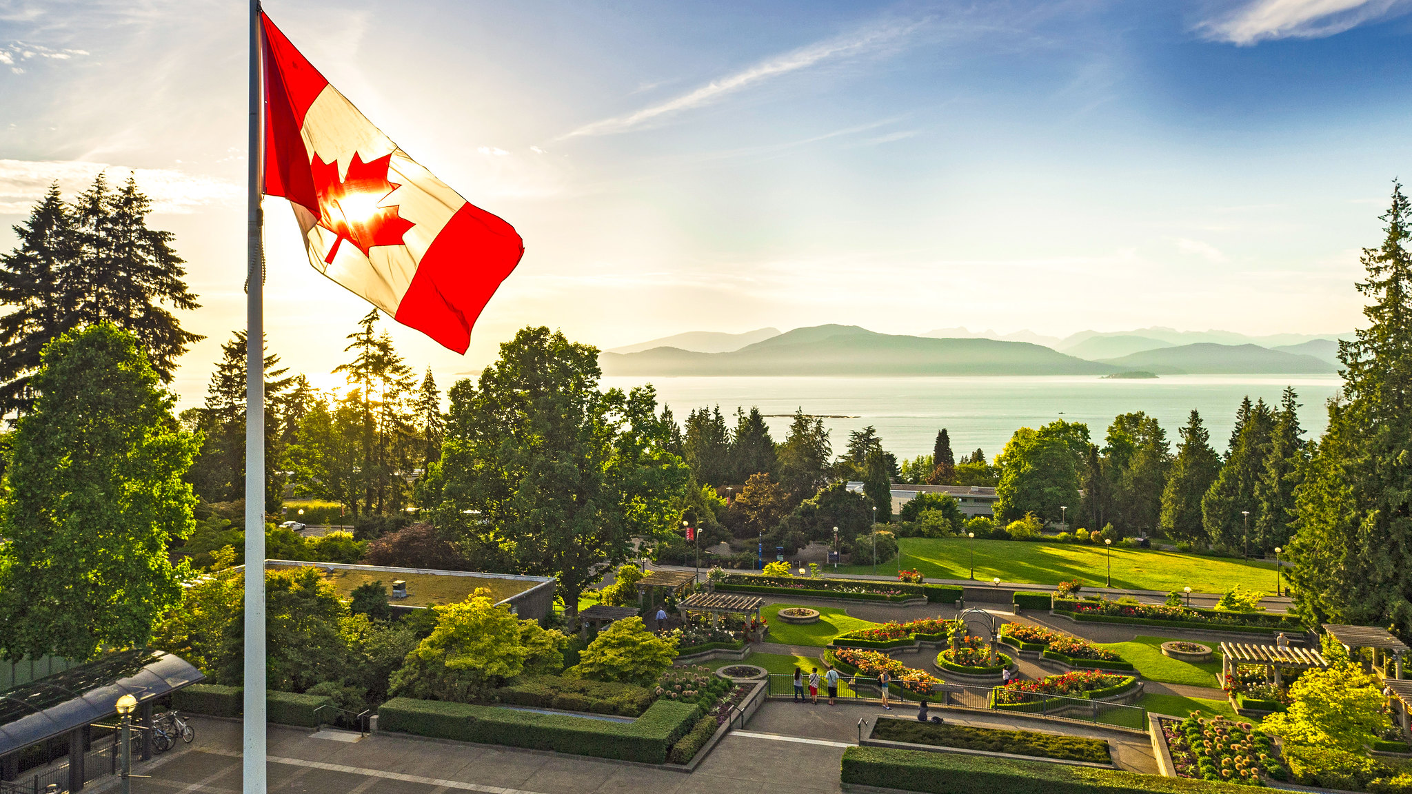 A picture of the UBC Rose Garden, with the Canadian flag in the foreground.