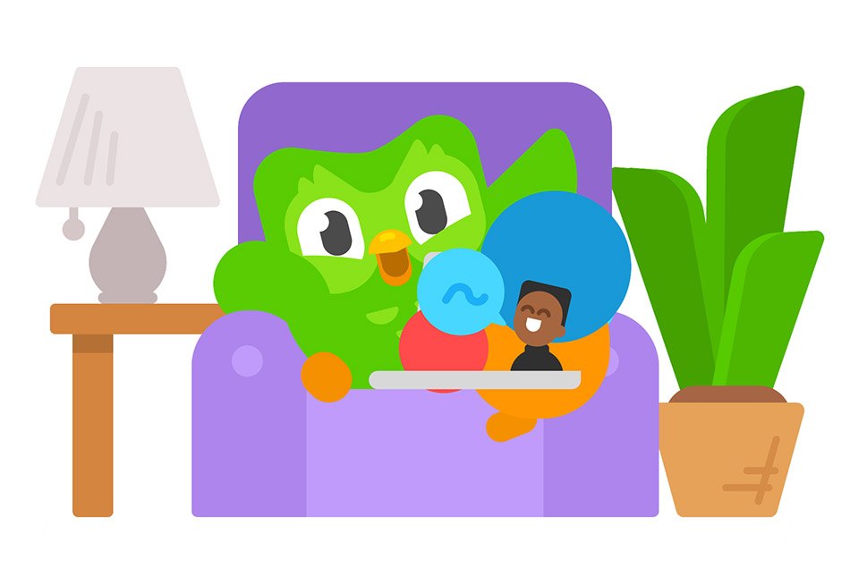 An image of the Duolingo owl siting in a purple armchair with a lamp and a potplant at the side and a laptop in its lap