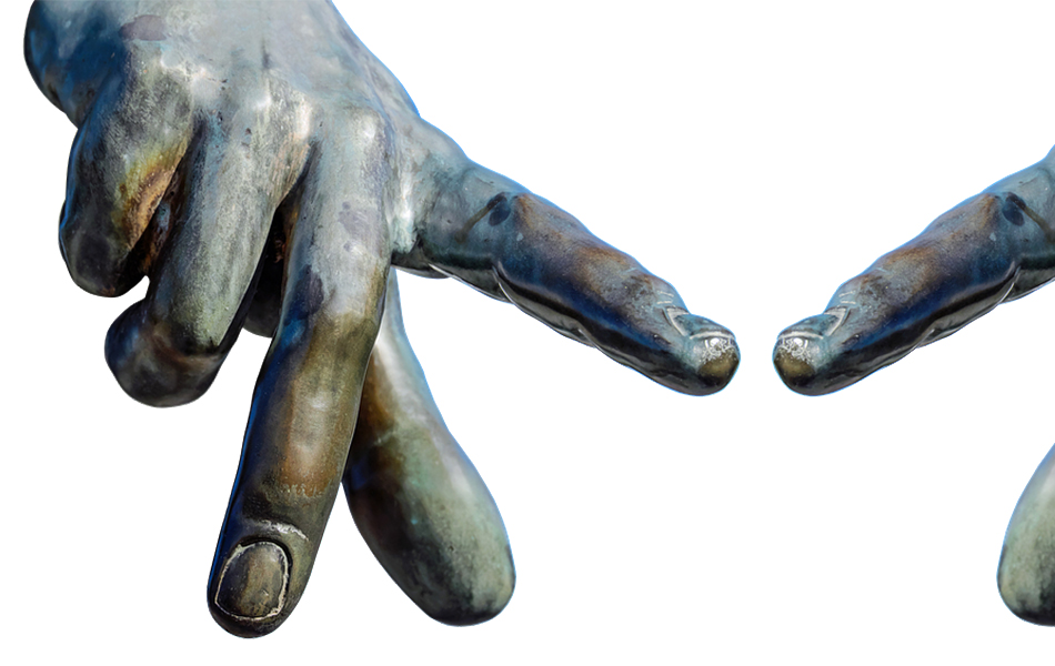 A picture of part of a brass statues hands, reaching out with index fingers almost touching.
