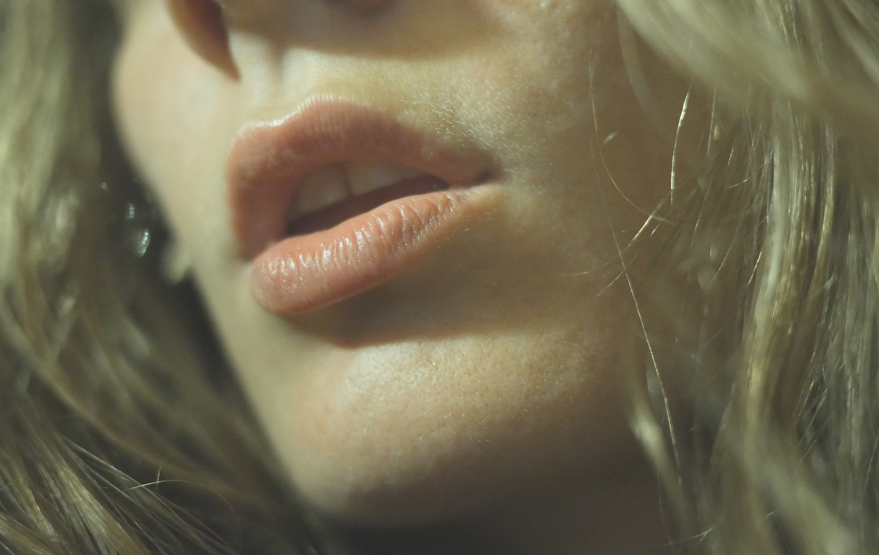 A close up on a woman's mouth and cheeks
