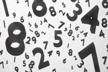 Graphic image of black-coloured numbers scattered on a white background
