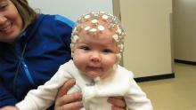 A picture of a baby study participant wearing an EEG cap in Dr. Janet Werker’s Infant Studies Centre.