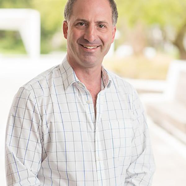 A headshot of Paul Bartha standing outside