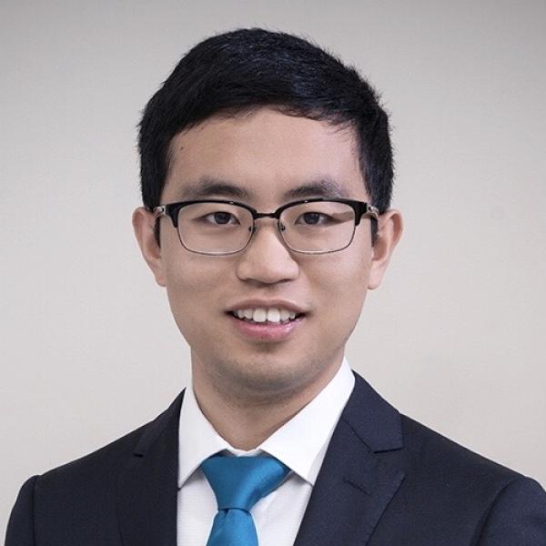 A headshot of Chiyu Zhang standing against a grey background